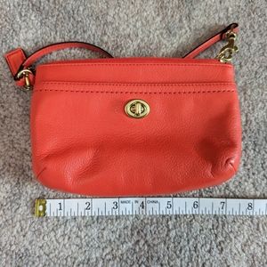 Coach leather wristlet, coral color.